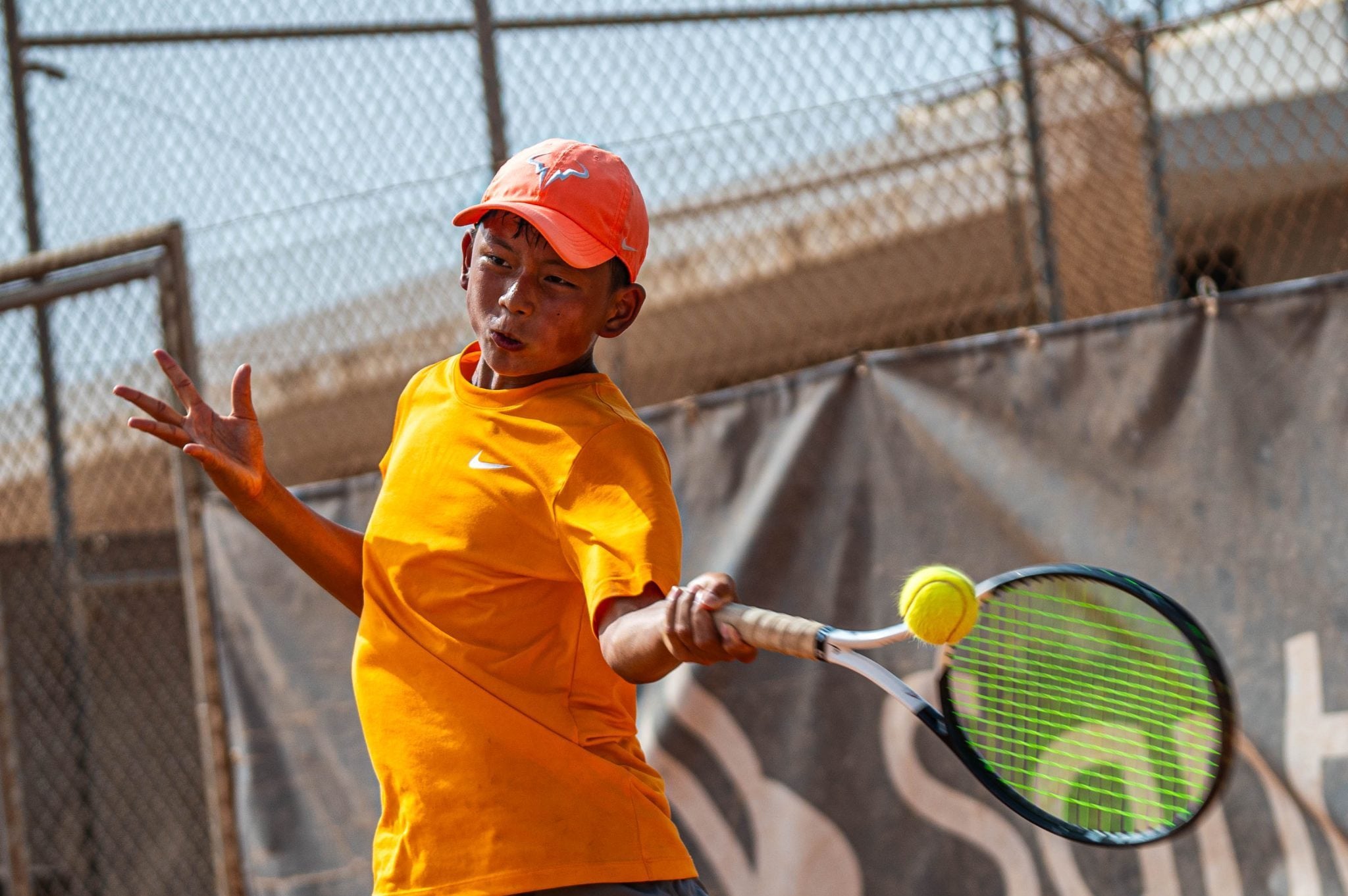 Junior tennis players competing in ITF tournament