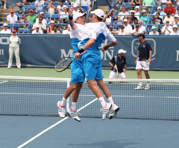 Bryan Brothers in tennis doubles action showcasing perfect teamwork