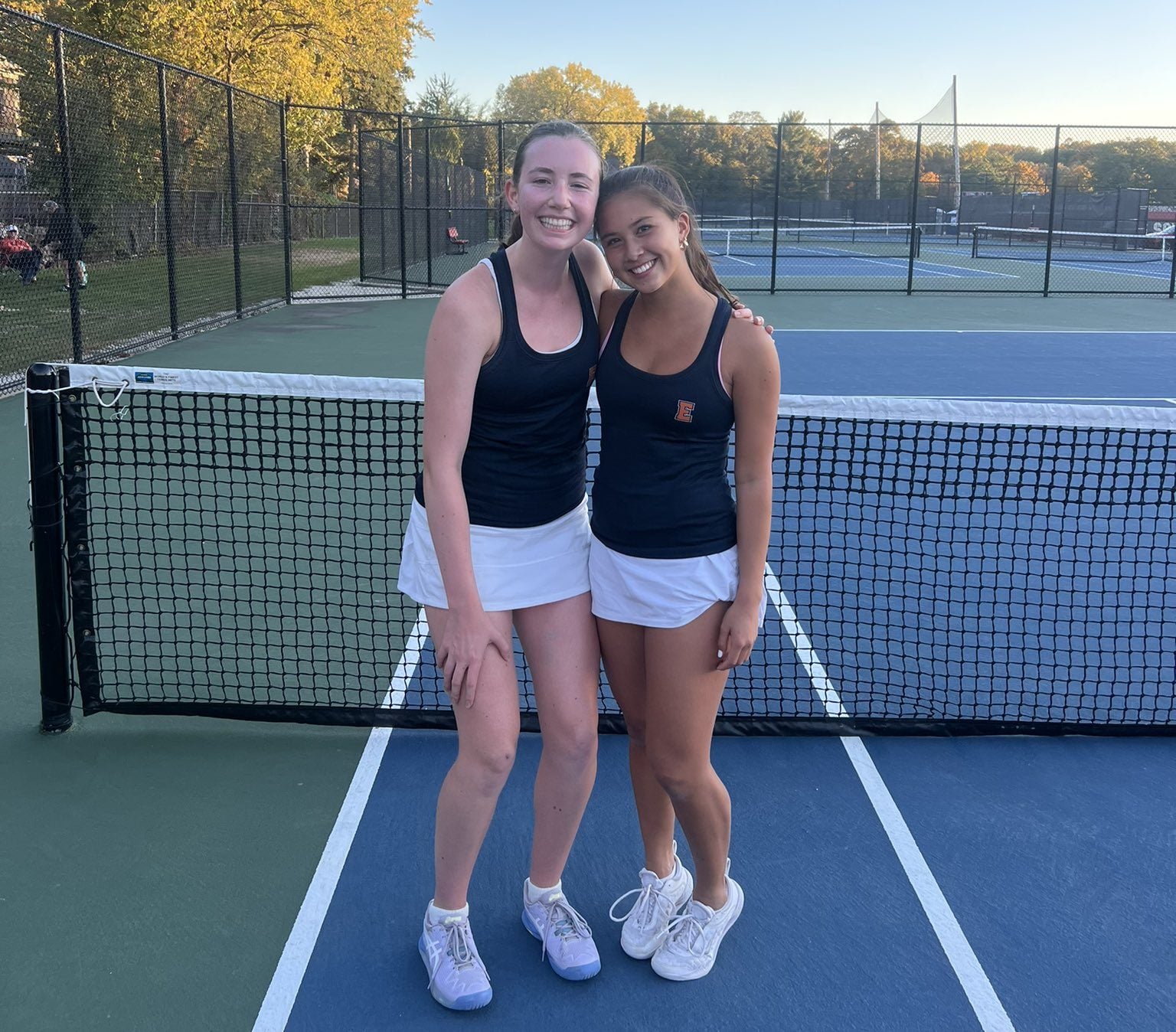 High school girls tennis doubles team in action